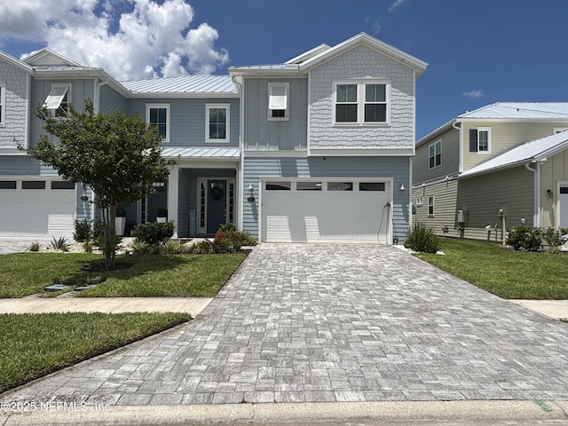 627 Rum Runner Way, Saint Johns, FL 32259 - view of front of property with decorative driveway, a front yard, an attached garage, a metal roof, and a standing seam roof