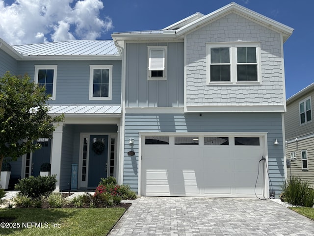 627 Rum Runner Way, Saint Johns, FL 32259 - view of front facade with an attached garage, a standing seam roof, decorative driveway, and a metal roof