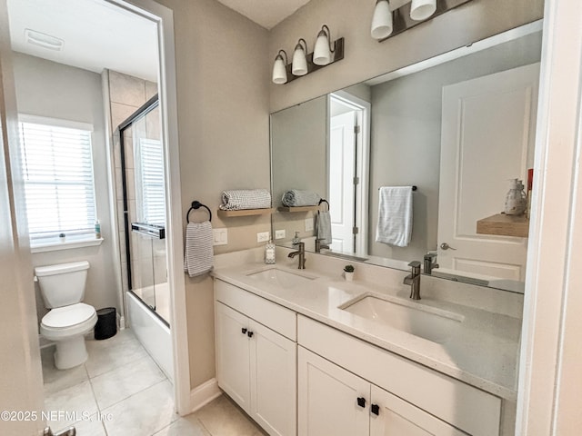 627 Rum Runner Way, Saint Johns, FL 32259 - bathroom featuring double vanity, tile patterned flooring, and combined bath / shower with glass door