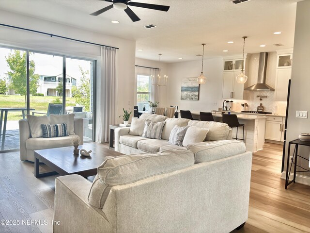 627 Rum Runner Way, Saint Johns, FL 32259 - living room with light wood-style flooring, ceiling fan, recessed lighting, and a chandelier