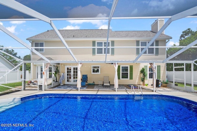 5950 Orchard Pond Dr, Fleming Island, FL 32003 - back of property with french doors, a patio, fence, and a lanai