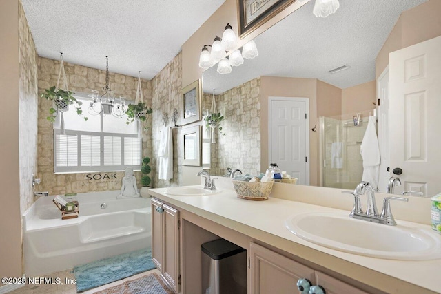 5950 Orchard Pond Dr, Fleming Island, FL 32003 - full bath with a shower stall, a bath, a textured ceiling, double vanity, and a chandelier