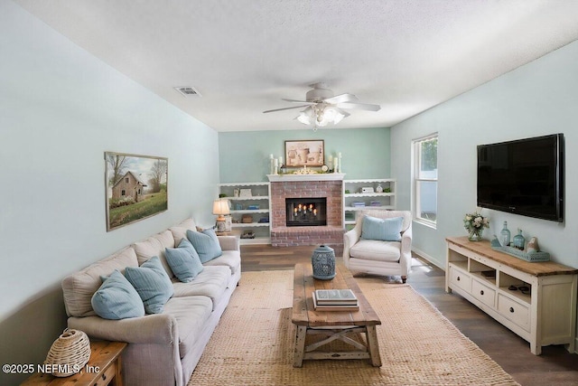 5950 Orchard Pond Dr, Fleming Island, FL 32003 - living area featuring a ceiling fan, dark wood-style floors, and a fireplace