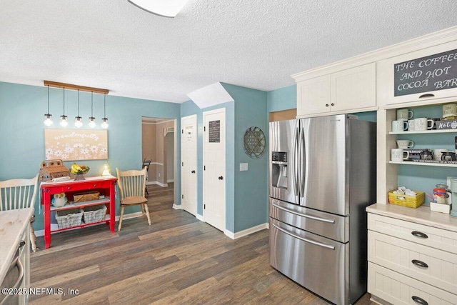 5950 Orchard Pond Dr, Fleming Island, FL 32003 - kitchen featuring stainless steel fridge with ice dispenser, dark wood-style floors, light countertops, a textured ceiling, and white cabinetry