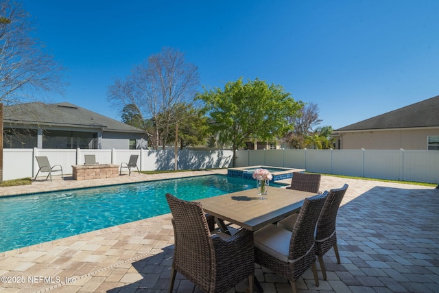 475 Pine Eagle Dr, Fleming Island, FL 32003 - view of pool featuring a patio area, a fenced backyard, a pool with connected hot tub, an outdoor fire pit, and outdoor dining space