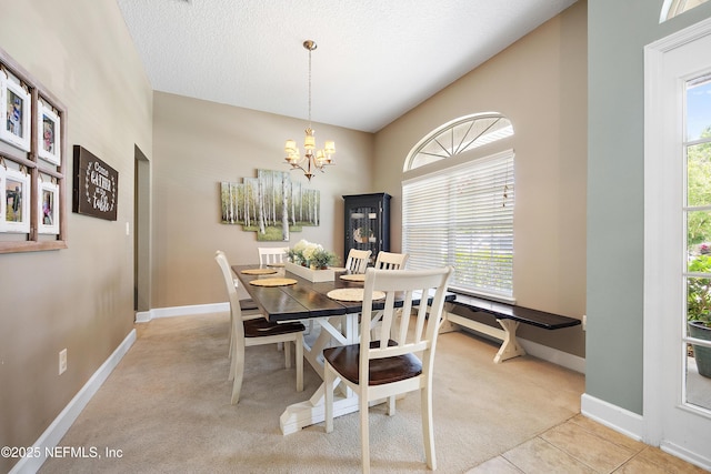 dining space with light colored carpet, a chandelier, and baseboards