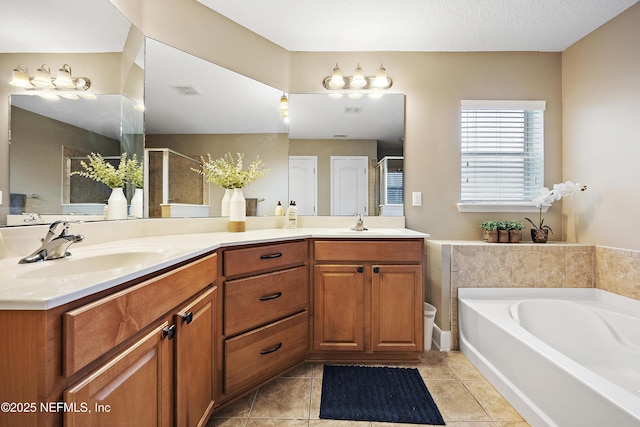 full bath with a stall shower, a bath, double vanity, and tile patterned flooring