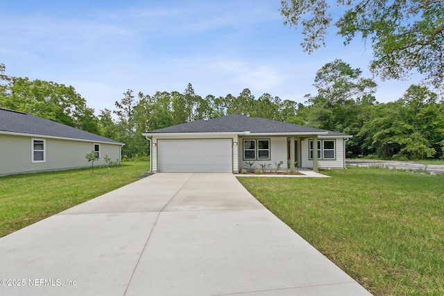 view of front of house featuring a front lawn, driveway, and an attached garage