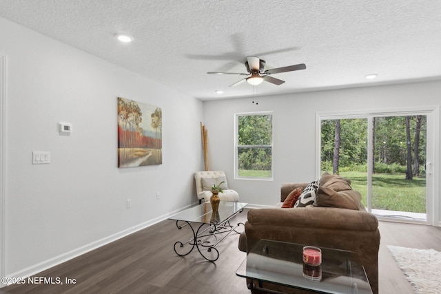 living room featuring a ceiling fan, wood finished floors, a textured ceiling, recessed lighting, and baseboards