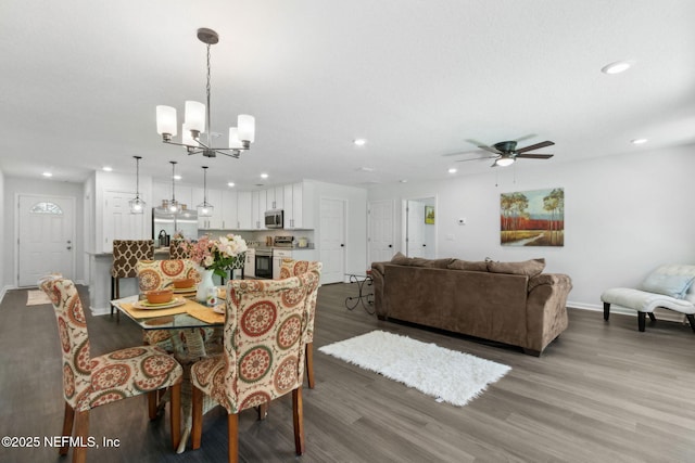 dining room featuring recessed lighting, wood finished floors, a chandelier, baseboards, and a ceiling fan