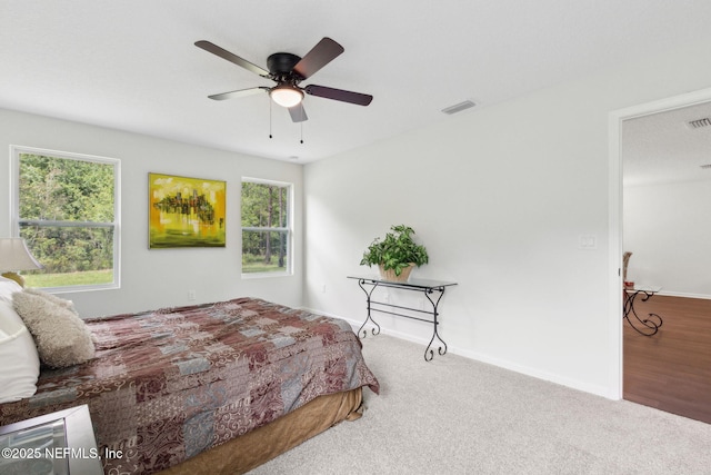 bedroom featuring multiple windows, carpet flooring, baseboards, and ceiling fan