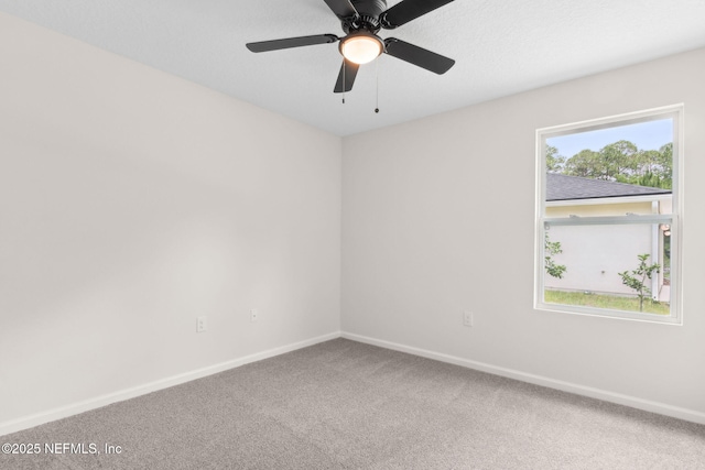 carpeted empty room with baseboards and ceiling fan