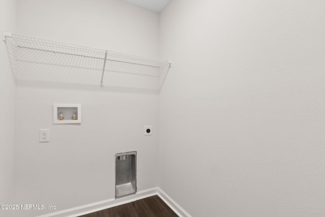 clothes washing area featuring hookup for a washing machine, electric dryer hookup, baseboards, and dark wood finished floors