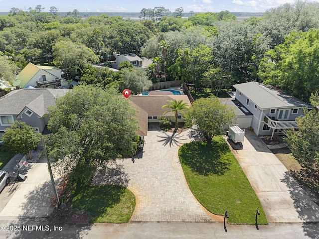 view from above of property with a tree filled landscape