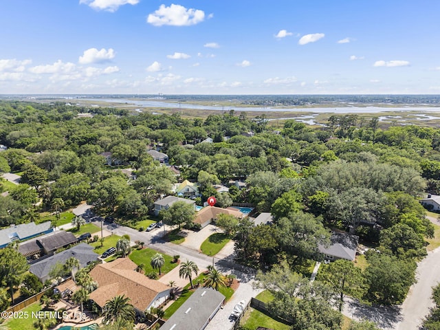 aerial view of property's location featuring a large body of water and nearby suburban area