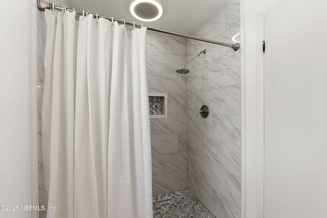 full bath with a tile shower