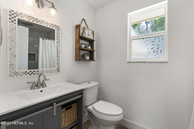 full bathroom featuring toilet, vanity, and a shower with shower curtain