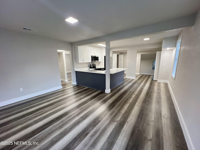 3133 Gilmore St, Jacksonville, FL 32205 - unfurnished living room with baseboards and dark wood-style floors