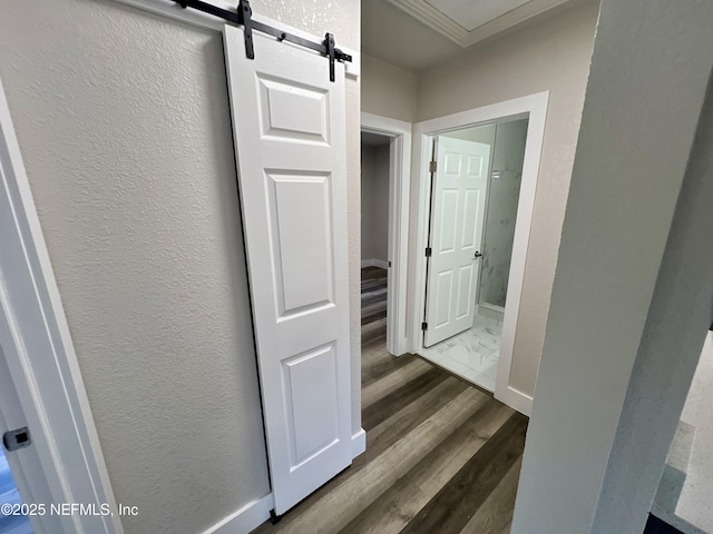3133 Gilmore St, Jacksonville, FL 32205 - corridor featuring dark wood-style floors, a textured wall, ornamental molding, a barn door, and baseboards