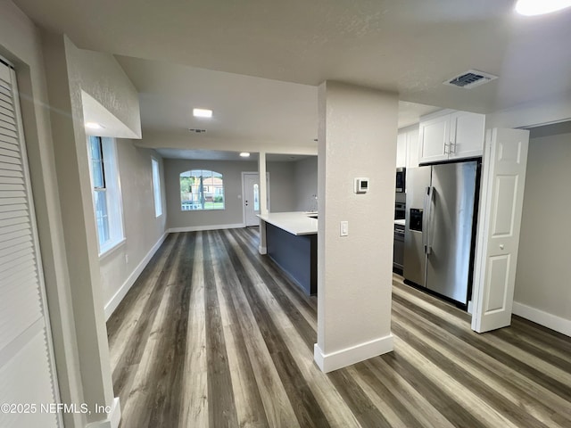 3133 Gilmore St, Jacksonville, FL 32205 - kitchen with stainless steel refrigerator with ice dispenser, dark wood finished floors, baseboards, and light countertops