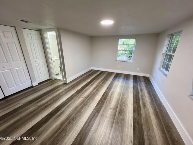 3133 Gilmore St, Jacksonville, FL 32205 - unfurnished bedroom with baseboards and dark wood finished floors