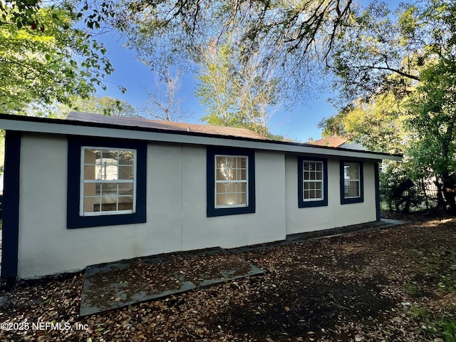 3133 Gilmore St, Jacksonville, FL 32205 - view of side of home featuring stucco siding