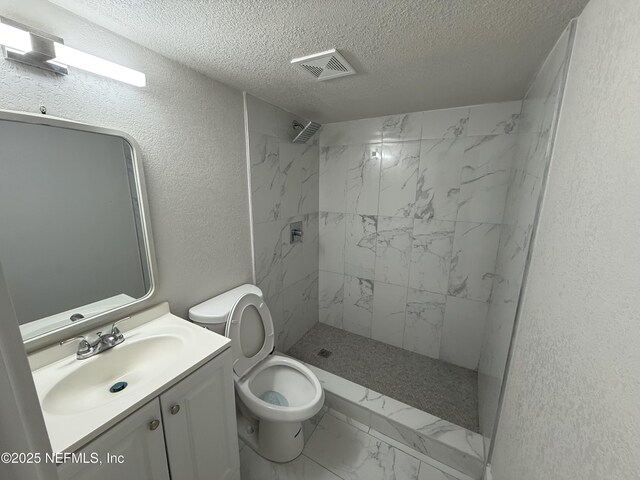3133 Gilmore St, Jacksonville, FL 32205 - full bath featuring marble look tiles, a textured ceiling, toilet, a textured wall, and a marble finish shower