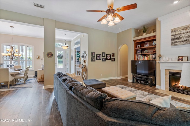 400 N Landguard Rd, Saint Augustine, FL 32092 - living area featuring wood finished floors, arched walkways, a tile fireplace, ceiling fan, and baseboards