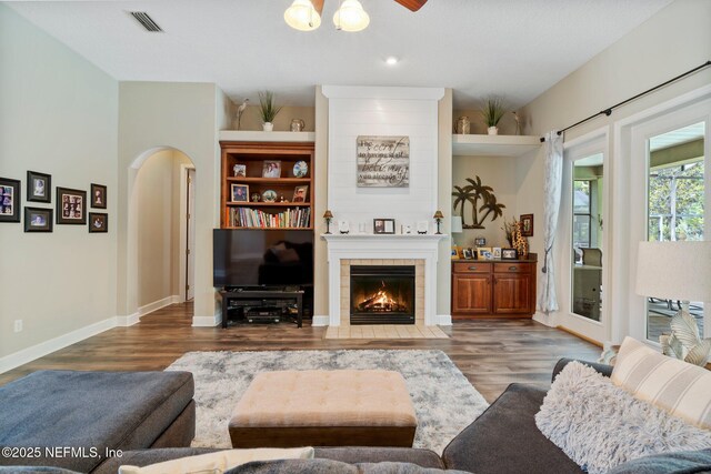 400 N Landguard Rd, Saint Augustine, FL 32092 - living room featuring wood finished floors, arched walkways, a fireplace, a ceiling fan, and recessed lighting