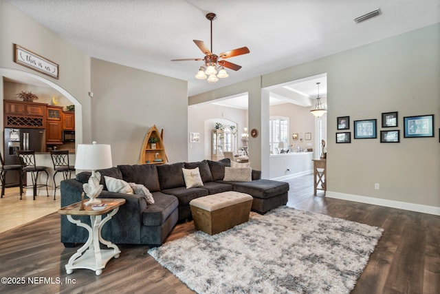 400 N Landguard Rd, Saint Augustine, FL 32092 - living room with a ceiling fan, dark wood-style floors, arched walkways, and baseboards