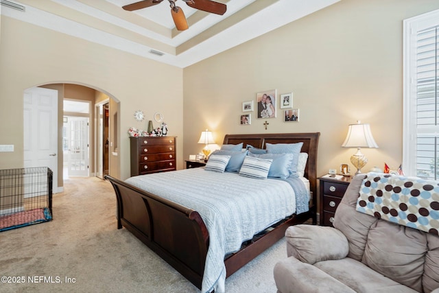 400 N Landguard Rd, Saint Augustine, FL 32092 - bedroom featuring arched walkways, light colored carpet, a raised ceiling, ensuite bathroom, and a ceiling fan