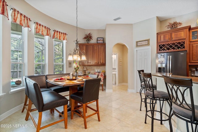400 N Landguard Rd, Saint Augustine, FL 32092 - dining space with arched walkways, healthy amount of natural light, light tile patterned floors, and baseboards