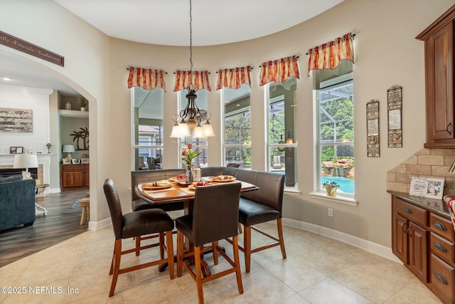 400 N Landguard Rd, Saint Augustine, FL 32092 - dining room featuring a chandelier, light tile patterned floors, baseboards, and arched walkways