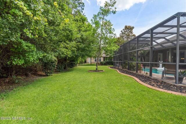 400 N Landguard Rd, Saint Augustine, FL 32092 - view of green lawn featuring an outdoor pool, glass enclosure, and a patio