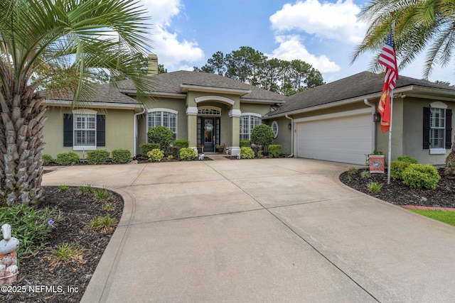 400 N Landguard Rd, Saint Augustine, FL 32092 - view of front facade featuring stucco siding, driveway, an attached garage, and roof with shingles