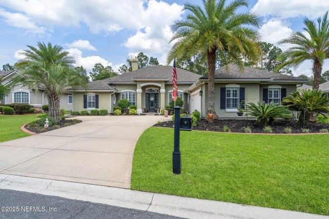 400 N Landguard Rd, Saint Augustine, FL 32092 - ranch-style house with an attached garage, stucco siding, driveway, a front yard, and a chimney