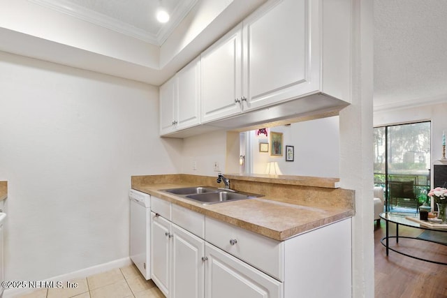 100 Fairway Park Blvd Unit 802, Ponte Vedra, FL 32082 - kitchen with ornamental molding, white dishwasher, white cabinetry, baseboards, and light countertops