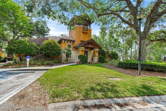 100 Fairway Park Blvd Unit 802, Ponte Vedra, FL 32082 - view of front of property featuring stucco siding, a front yard, uncovered parking, and stone siding