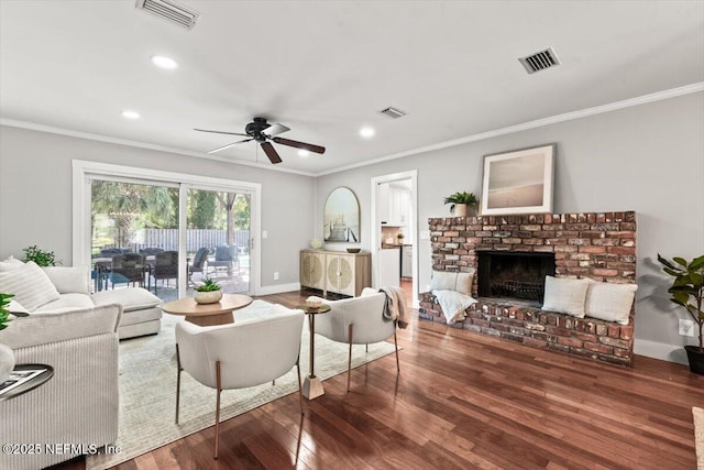 1659 Sea Oats Dr, Atlantic Beach, FL 32233 - living area featuring wood finished floors, crown molding, ceiling fan, a fireplace, and recessed lighting