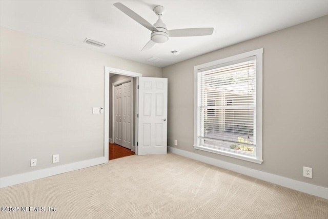 1659 Sea Oats Dr, Atlantic Beach, FL 32233 - unfurnished bedroom with carpet, baseboards, and a ceiling fan
