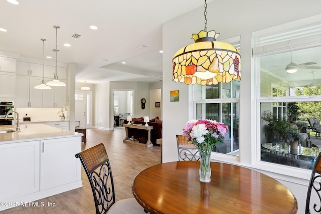 dining space with a ceiling fan, recessed lighting, and light wood finished floors