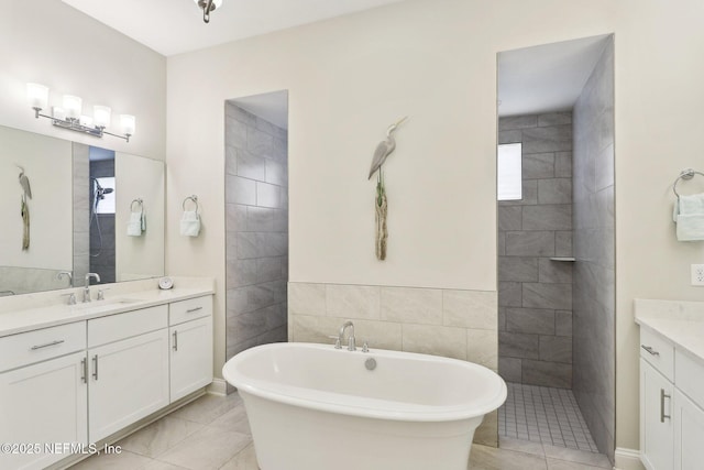 full bath featuring vanity, a soaking tub, a tile shower, healthy amount of natural light, and tile walls