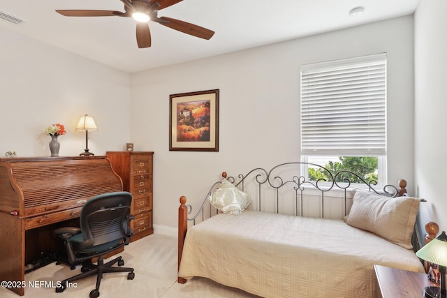 bedroom with light colored carpet, ceiling fan, and baseboards
