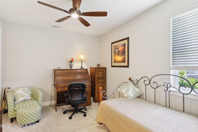 bedroom with light carpet, ceiling fan, and baseboards