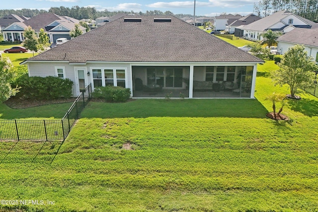 back of property featuring a residential view, a sunroom, and a shingled roof