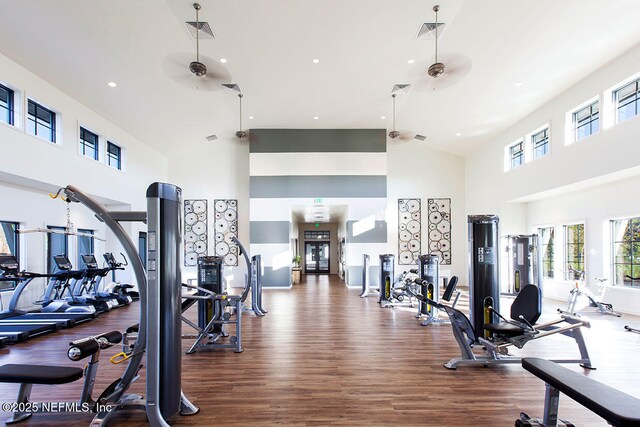 gym with high vaulted ceiling, wood finished floors, recessed lighting, and ceiling fan