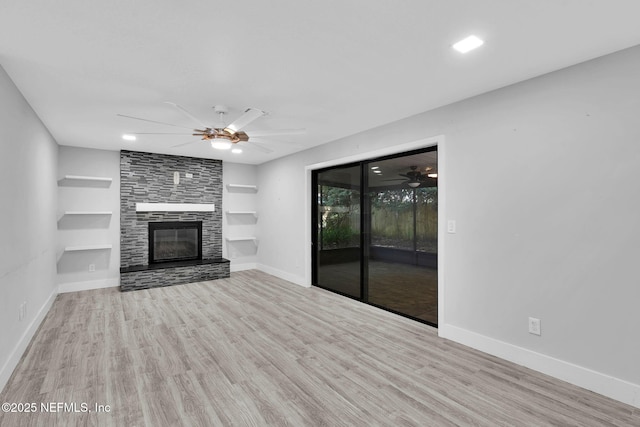 2032 Sandpiper Pt, Neptune Beach, FL 32266 - unfurnished living room with a ceiling fan, wood finished floors, a large fireplace, and built in features