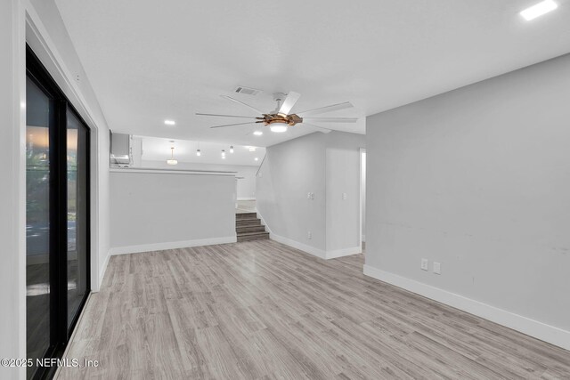 2032 Sandpiper Pt, Neptune Beach, FL 32266 - unfurnished living room featuring a ceiling fan, wood finished floors, and stairs