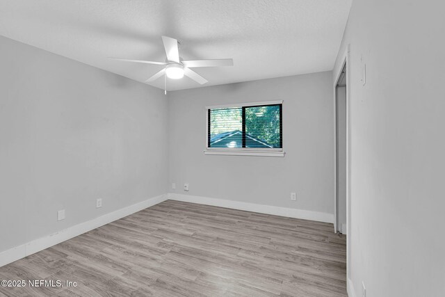 2032 Sandpiper Pt, Neptune Beach, FL 32266 - unfurnished bedroom with wood finished floors, a textured ceiling, and a ceiling fan