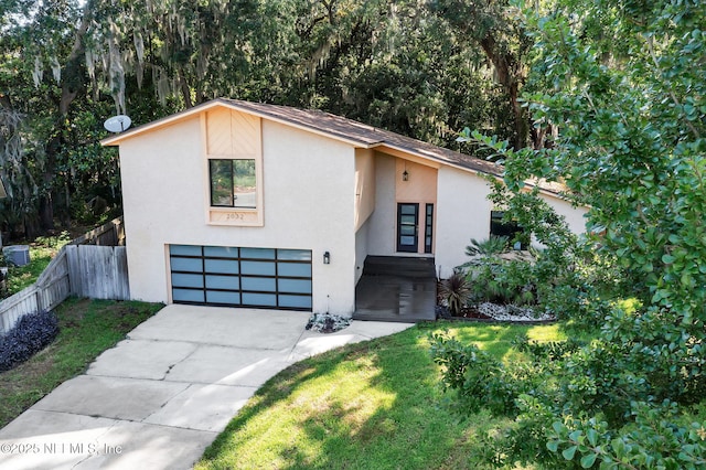 2032 Sandpiper Pt, Neptune Beach, FL 32266 - view of front of house featuring stucco siding, an attached garage, and driveway
